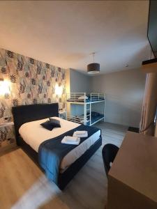 a hotel room with a bed and a desk at New Windsor in Étretat +6 photos