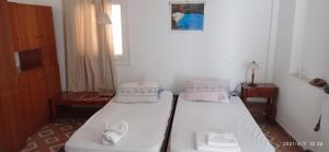 a room with two beds and a window at Faneromeni Two bed Apartment B (1st Floor) in Zakynthos Town