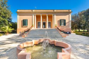 a building with a fountain in front of it at B&B Luxury da Salvatore in Presicce