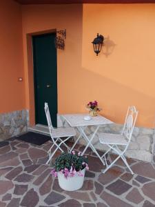 uma mesa e duas cadeiras e uma porta verde em B&B Ferro di Cavallo em Tivoli