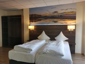 a bedroom with two beds with a painting on the wall at Hotel Albert II Oostende in Ostend