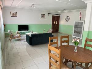 a living room with a table and a couch at Domaine des Maldives in Yaoundé