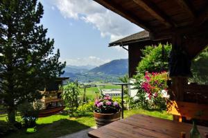 a patio with a table and a view of a valley at Heissgut in Altenmarkt im Pongau