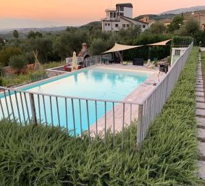 a swimming pool with a fence around it at Palazzo Sabini in Pertosa