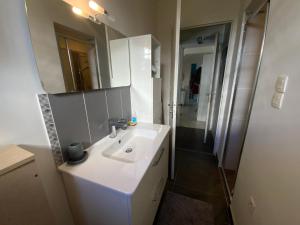 a bathroom with a white sink and a mirror at Belle chambre au calme centre Montpellier in Montpellier