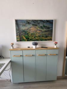 a painting hanging on a wall above a desk at Studio bien équipé, situé en hyper centre in Vendôme
