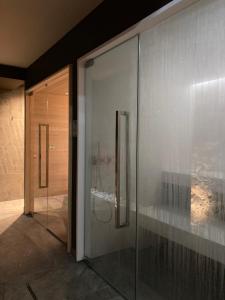 a glass facade of a building with a glass door at Encanto Agriturismo & Private SPA in Visogliano