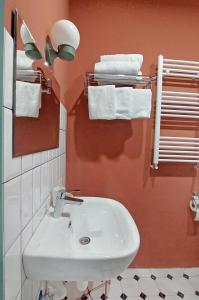 a bathroom with a white sink and towels at Gudauri Roshka Studio Apt #412 in Gudauri