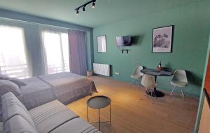 a bedroom with a bed and a table and chairs at Gudauri Roshka Studio Apt #412 in Gudauri