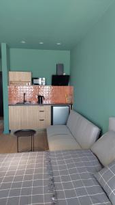 a living room with a couch and a kitchen at Gudauri Roshka Studio Apt #412 in Gudauri