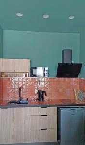 a kitchen with a red tiled counter top at Gudauri Roshka Studio Apt #412 in Gudauri