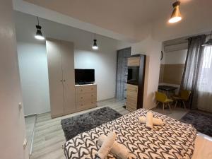 a bedroom with a bed and a television in it at OTHER STORIES / Palas Retreat in Iaşi