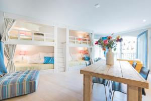 a room with a dining table and bunk beds at Flo's Atelier - Family studio NOTE studio is adjacent to Flo's apartment in Amsterdam