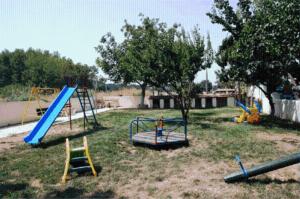 a group of playground equipment in a yard at Achillion Palace in Kalambaki