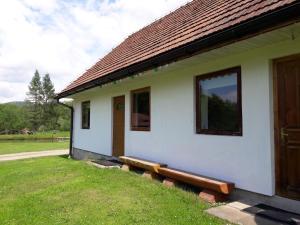 a building with a bench in front of it at Domek wiejski in Dwernik