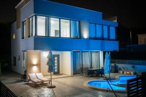 a blue house with a swimming pool in front of it at Luxury Scandinavian in Ulcinj