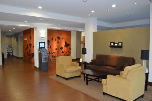 a waiting room with two chairs and a cash register at Sleep Inn & Suites Elk City in Elk City