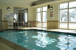 a large swimming pool in a room with windows at Sleep Inn & Suites Elk City in Elk City