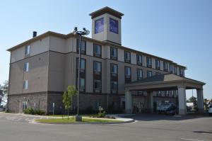 a building with a clock tower on top of it at Sleep Inn & Suites Elk City in Elk City