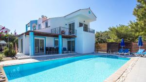 a villa with a swimming pool and a house at Villa Selene in Archangelos