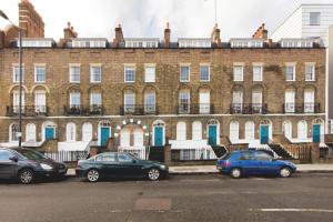 a large brick building with cars parked in front of it at Franks Pied-à-terre in London-Quiet,Bright,Central in London