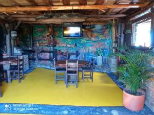 a room with a table and chairs and a wall with graffiti at Alojamiento Rural Altos del Molino in Los Andes