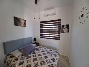 a bedroom with a bed and a window with pictures at Hacienda Gallardos 104-2 in San Carlos +82 photos