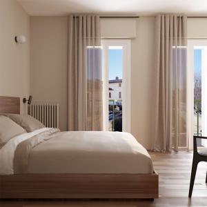 a bedroom with a large bed and a window at La Dama del Porto in Laveno-Mombello