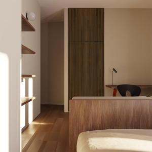 a bedroom with a bed and a desk with a chair at La Dama del Porto in Laveno-Mombello