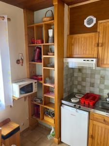 a kitchen with a stove and a microwave at Chalet "Le Mayouret" - STUDIO N°4 - chemin des écureuils in Cauterets