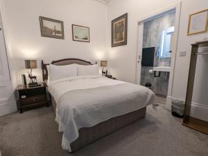 a bedroom with a large bed and a window at Cambeth Lodge in Inverness