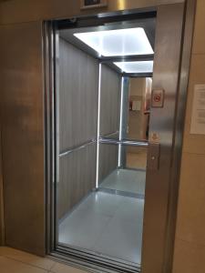 an empty room with a glass door in a elevator at Hotel Albert II Oostende in Ostend