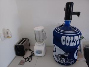 a bottle of cola sitting on a counter next to a blender at Hacienda Gallardos 104-2 in San Carlos