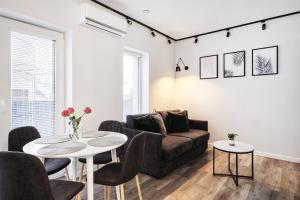 a living room with a couch and a table at Owls Hill Apartment in Kaunas