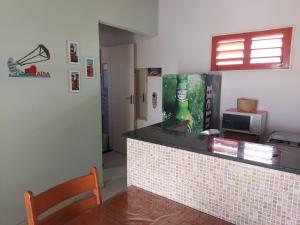 a restaurant with a tile counter and a table at Moreira's paradise in Taíba