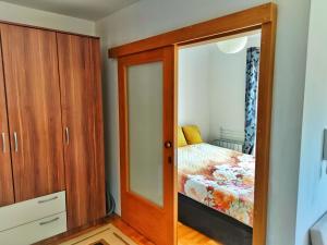 a bedroom with a cabinet and a bed at APARTMAN SNOW Vlašić in Vlasic