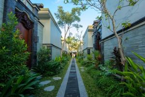 a walkway between buildings in a residential neighbourhood at Bali Corail Villas in Kerobokan