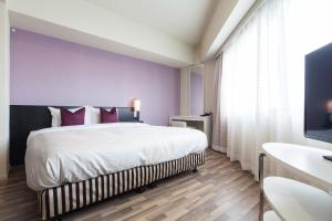 Postel nebo postele na pokoji v ubytování Sakura Terrace