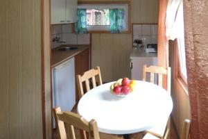 a kitchen with a table with a bowl of fruit on it at Bungalows in Wrzosowo The Bird s Cage for 4 persons in Wrzosowo