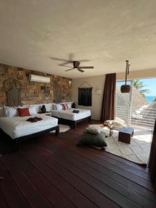 a living room filled with furniture and a large window at Alma Tulum Hotel Boutique in Tulum