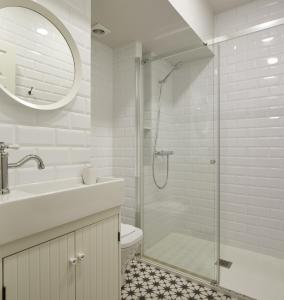a white bathroom with a shower and a sink at Aukera - Basque Stay in San Sebastián