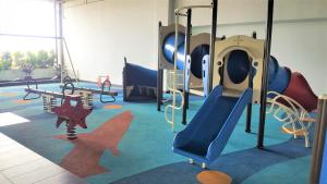 a play room with a slide and a playground at Prestige Sky Riverfront in Kota Bharu