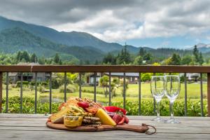a plate of food and two wine glasses on a table at *** LAKE VILLA 459 *** in Hanmer Springs