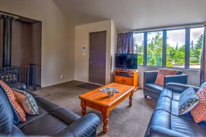a living room with two couches and a coffee table at *** LAKE VILLA 459 *** in Hanmer Springs
