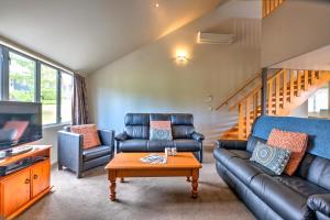 a living room with a couch and a table at *** LAKE VILLA 459 *** in Hanmer Springs