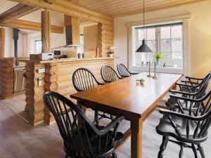 a kitchen and dining room with a wooden table and chairs at 10 person holiday home in Væggerløse-By Traum in Marielyst