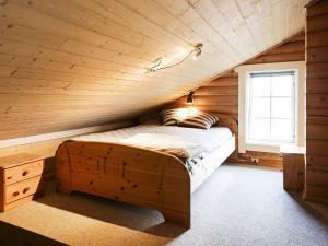 a bedroom with a bed in a wooden room at 10 person holiday home in Væggerløse-By Traum in Marielyst