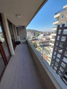 a balcony of a building with a view of a city at Edifico claro solar piso 16 in Temuco