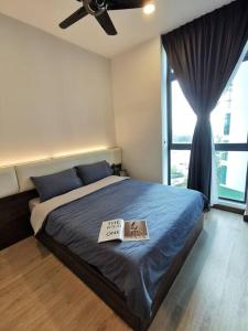 a bedroom with a bed with a book on it at Grand Suites 4BR 12Pax Gathering First Choice WIFI NETFLIX!! 60"TV By STAY in Masai