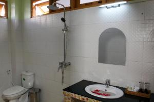 a bathroom with a sink and a toilet at Sandalwood Hotel in Nyaung Shwe